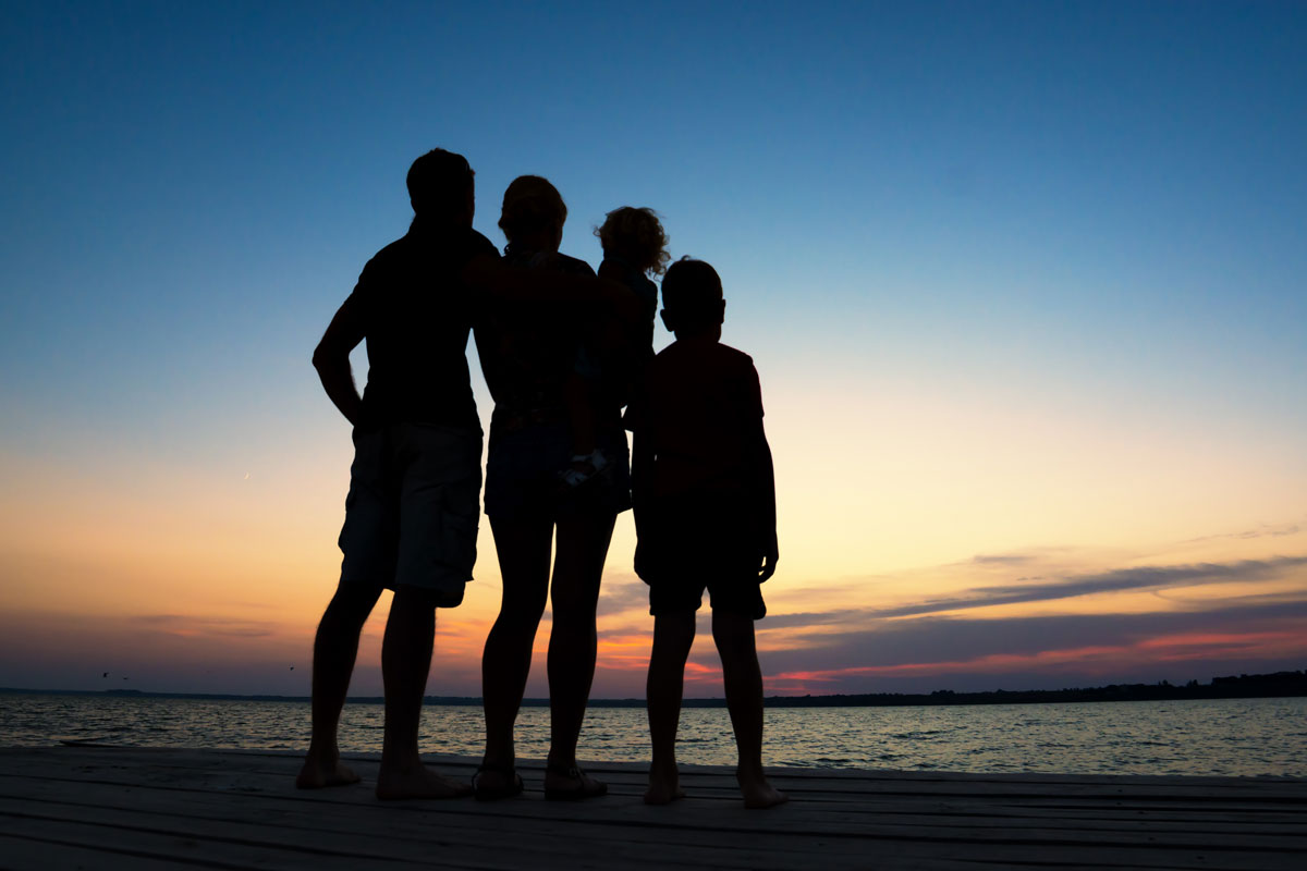 Silhouette of a family watching sunset at the beach in the Florida Keys